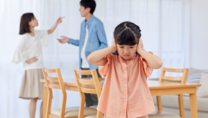 A couple argues in front of their child.